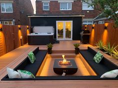 an outdoor living area with couches and fire pit