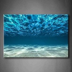 an underwater scene with blue water and sand