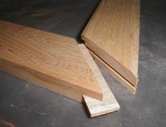 two pieces of wood sitting on top of a table next to each other with one piece missing