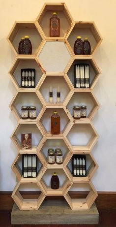 a wooden shelf filled with lots of different types of condiments on top of it