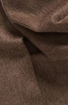 close up view of brown wool fabric with very soft folds on the top and bottom