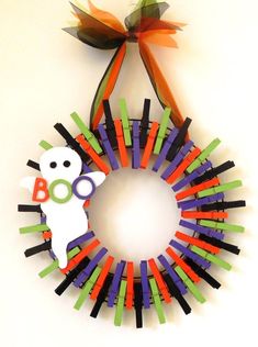 a halloween wreath made out of colored sticks