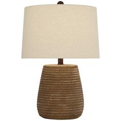 a table lamp with a beige shade on it