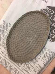 a close up of a plate on top of a newspaper