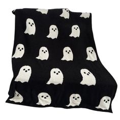 a black blanket with white ghost faces on it