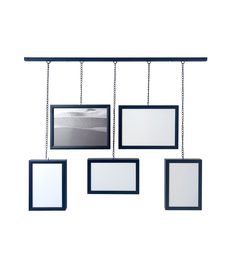 four frames hanging from a metal bar with chains