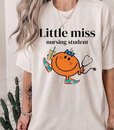 a woman wearing a t - shirt that says little miss nursing student