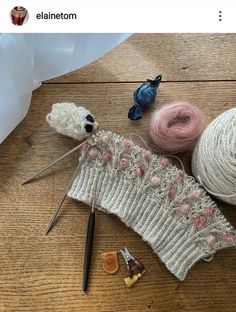 yarn and knitting needles laid out on a table