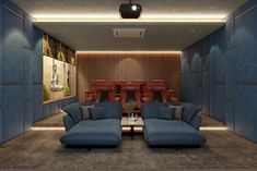 a living room filled with blue couches next to a wall mounted movie projector