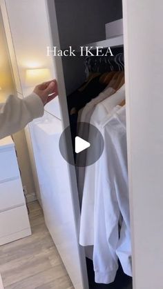 a person is looking at clothes in a closet