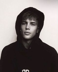 a black and white photo of a person wearing a hoodie