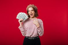 a woman in a red and white striped shirt is holding money