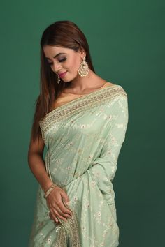 Be a vision of style and elegance at parties in this beautiful pastel green Benarasi sari with embroidered border. It comes with a matching blouse piece. Shop designer sarees online in USA from Pure Elegance. DISCLAIMER:- The shown stitched blouse on the model is for display purpose only. The saree comes with a matching blouse piece and finished with fall and piko. Green Banarasi Saree, Fashion Journals, Embroidered Border, Designer Sarees Online, Banarasi Saree, Traditional Fabric, Designer Sarees, Banarasi Sarees