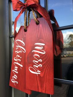 a red door hanger with the words merry christmas written on it