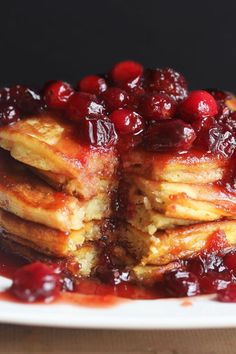 a stack of pancakes with cranberry sauce on top