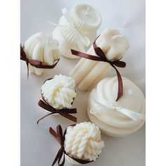 several different types of soaps tied together with ribbons on a white tablecloth background