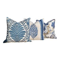 three pillows with blue and white designs on them