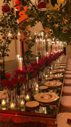 a long table is set with candles and plates