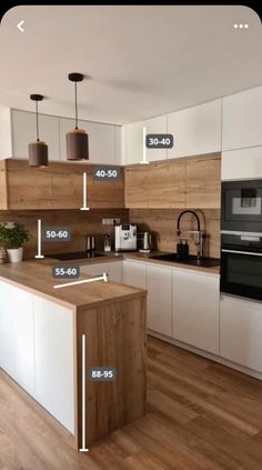 a kitchen with white cabinets and wood flooring has measurements for the countertop area