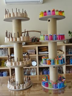 two wooden shelves with different types of thread spools on top of each shelf