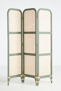 a room divider with three panels and gold trimmings on the sides, in green