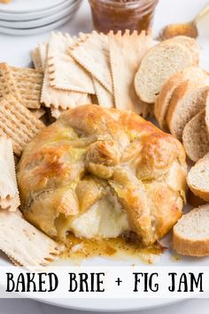 baked brie and fig jam on a plate with crackers, crackers and bread