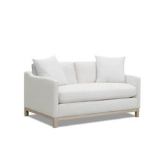 a white couch sitting on top of a wooden frame