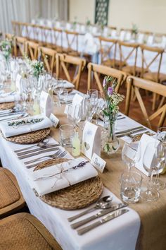 the tables are set with place settings and napkins