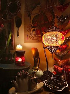 an assortment of decorative items on display in a dimly lit room