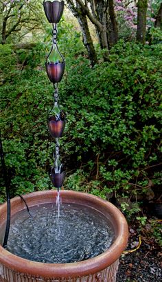 a water fountain in a pot filled with water