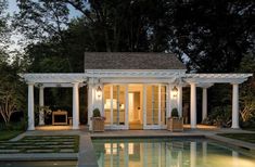 an outdoor pool and gazebo lit up at night