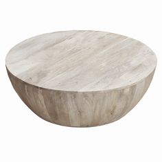 a round wooden table sitting on top of a white floor