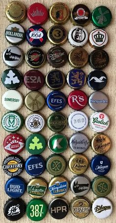 many different types of beer bottle caps are arranged on a table top with the number one