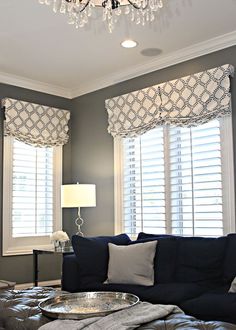 the living room is decorated in shades of gray and white, with chandelier