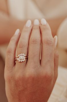 a woman's hand with a ring on it and a diamond in the middle