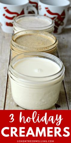 three jars filled with cream sitting on top of a wooden table