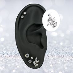 a pair of black acrylic ear plugs with clear crystal stones on them