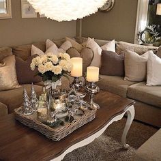 a living room filled with lots of furniture and flowers on top of a coffee table