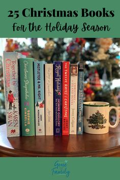 christmas books for the holiday season on a coffee table with a tree in the background