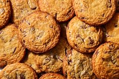 chocolate chip cookies are piled on top of each other