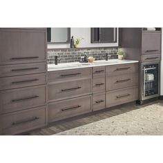 a kitchen with gray cabinets and white counter tops