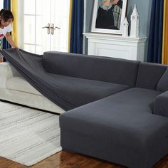 a woman unpacking a couch in a living room