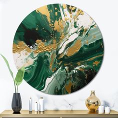 a green and gold abstract painting on a white wall