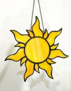 a stained glass sun hanging on a chain