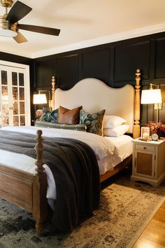 a bedroom with a large bed and two lamps