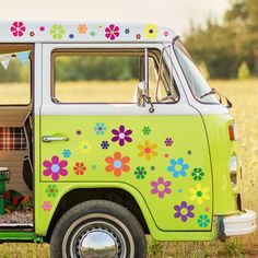 a green van with flowers painted on it's side and the door is open