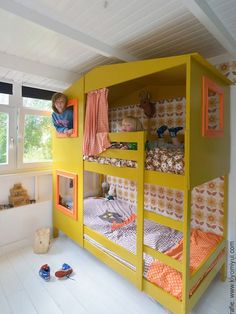 a child's bedroom with bunk beds and toys