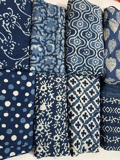 blue and white patterned fabrics are lined up together