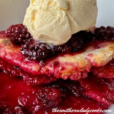 a close up of a plate of food with berries and ice cream on top,