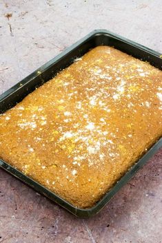 a pan filled with food sitting on top of a cement floor